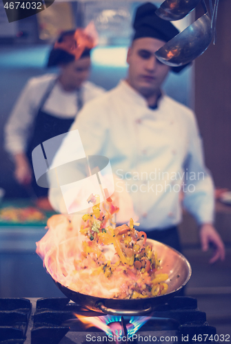 Image of Chef doing flambe on food