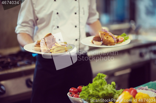 Image of Chef showing dishes of tasty meals
