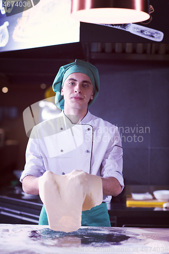 Image of chef throwing up pizza dough