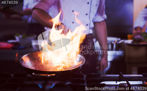 Image of Chef doing flambe on food