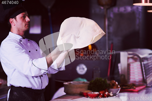 Image of chef throwing up pizza dough