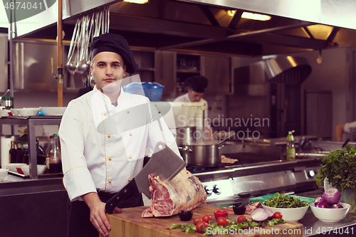 Image of chef cutting big piece of beef