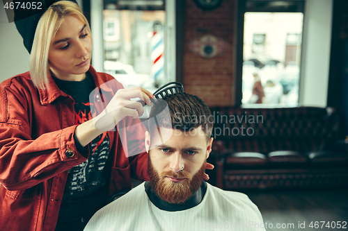 Image of Client during beard shaving in barber shop