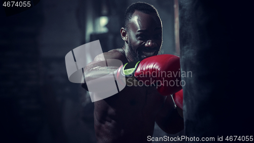 Image of Hand of boxer over black background. Strength, attack and motion concept