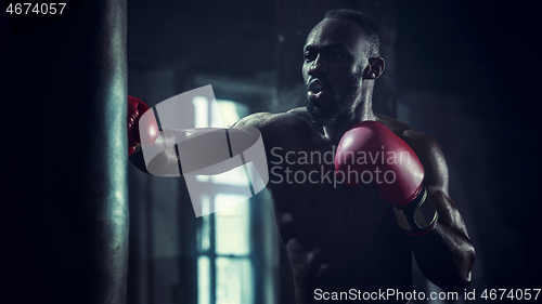 Image of Hand of boxer over black background. Strength, attack and motion concept