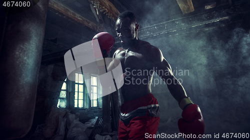 Image of Hand of boxer over black background. Strength, attack and motion concept