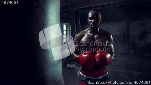 Image of Hand of boxer over black background. Strength, attack and motion concept