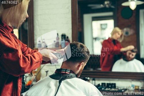 Image of Client during beard shaving in barber shop