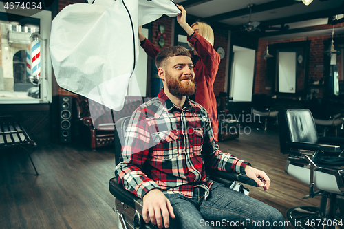 Image of Client during beard shaving in barber shop