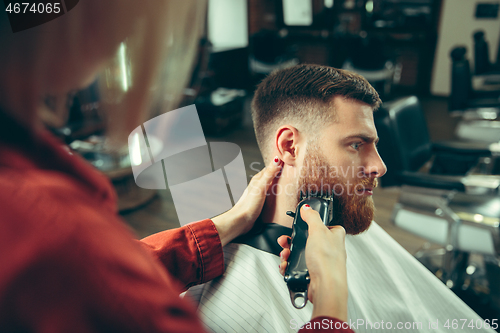 Image of Client during beard shaving in barber shop