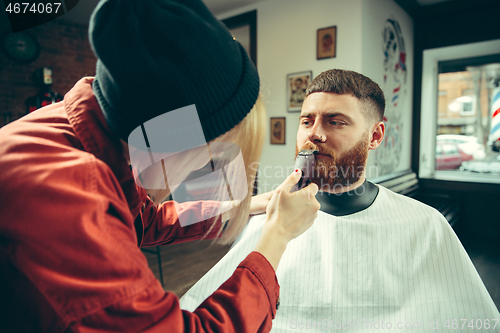 Image of Client during beard shaving in barber shop