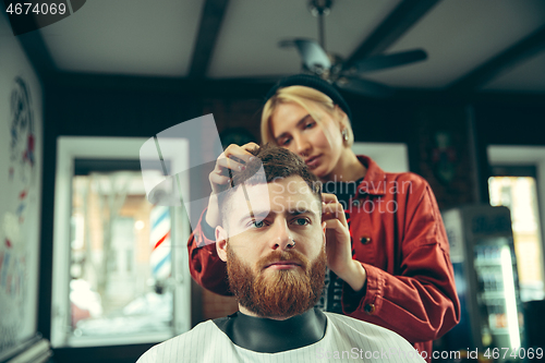 Image of Client during beard shaving in barber shop