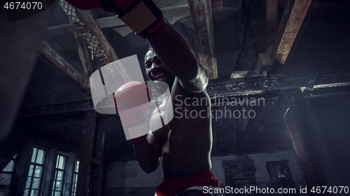 Image of Hand of boxer over black background. Strength, attack and motion concept