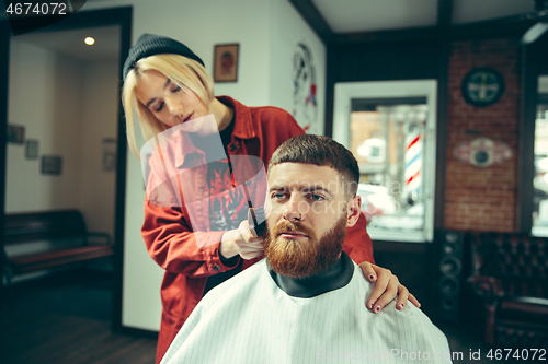 Image of Client during beard shaving in barber shop