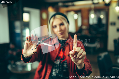 Image of Female barber in barber shop