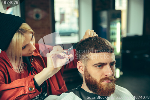 Image of Client during beard shaving in barber shop