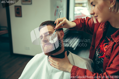 Image of Client during beard shaving in barber shop