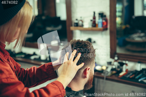 Image of Client during beard shaving in barber shop