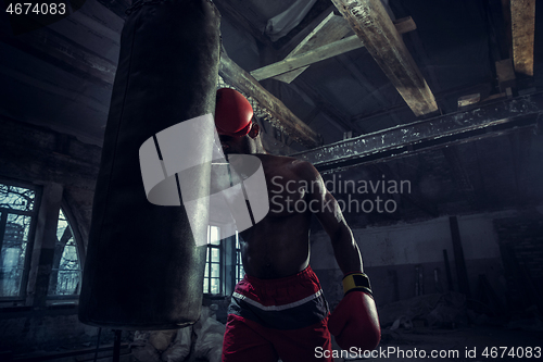 Image of Hand of boxer over black background. Strength, attack and motion concept