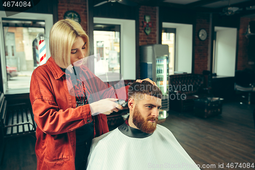 Image of Client during beard shaving in barber shop