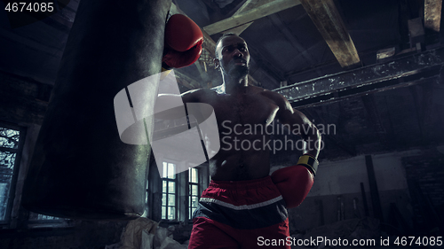 Image of Hand of boxer over black background. Strength, attack and motion concept