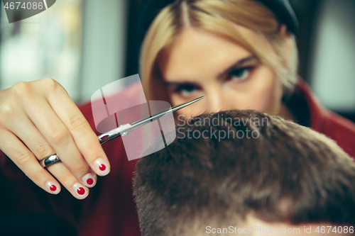 Image of Client during beard shaving in barber shop