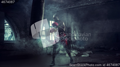 Image of Hand of boxer over black background. Strength, attack and motion concept