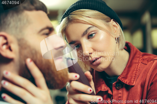 Image of Client during beard shaving in barber shop