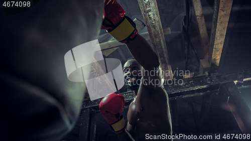 Image of Hand of boxer over black background. Strength, attack and motion concept
