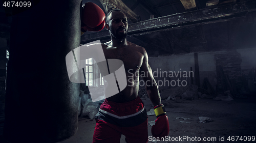 Image of Hand of boxer over black background. Strength, attack and motion concept