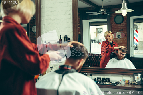 Image of Client during beard shaving in barber shop