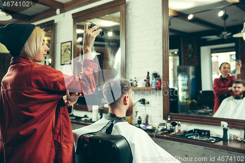 Image of Client during beard shaving in barber shop