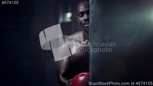 Image of Hand of boxer over black background. Strength, attack and motion concept