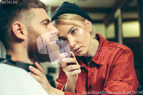 Image of Client during beard shaving in barber shop