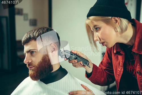 Image of Client during beard shaving in barber shop