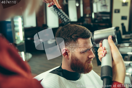 Image of Client during beard shaving in barber shop