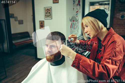 Image of Client during beard shaving in barber shop