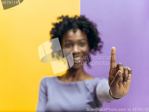 Image of Woman\'s hand with finger on blue background