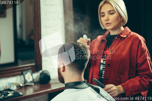 Image of Client during beard shaving in barber shop