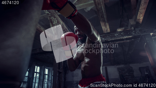 Image of Hand of boxer over black background. Strength, attack and motion concept