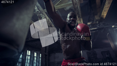 Image of Hand of boxer over black background. Strength, attack and motion concept