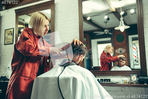 Image of Client during beard shaving in barber shop