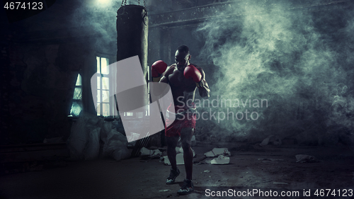 Image of Hand of boxer over black background. Strength, attack and motion concept