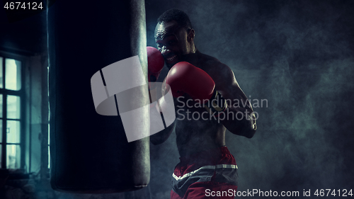 Image of Hand of boxer over black background. Strength, attack and motion concept