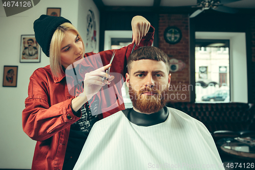 Image of Client during beard shaving in barber shop