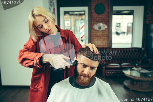 Image of Client during beard shaving in barber shop