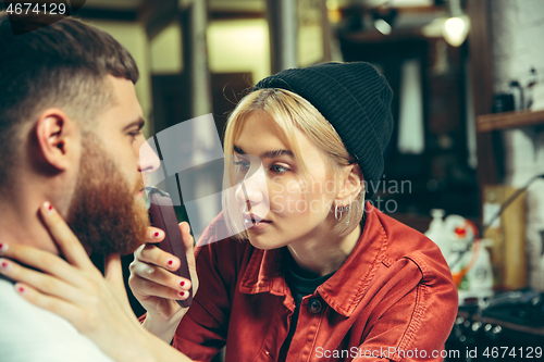 Image of Client during beard shaving in barber shop