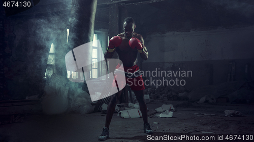 Image of Hand of boxer over black background. Strength, attack and motion concept