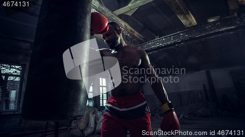 Image of Hand of boxer over black background. Strength, attack and motion concept