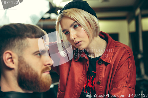 Image of Client during beard shaving in barber shop